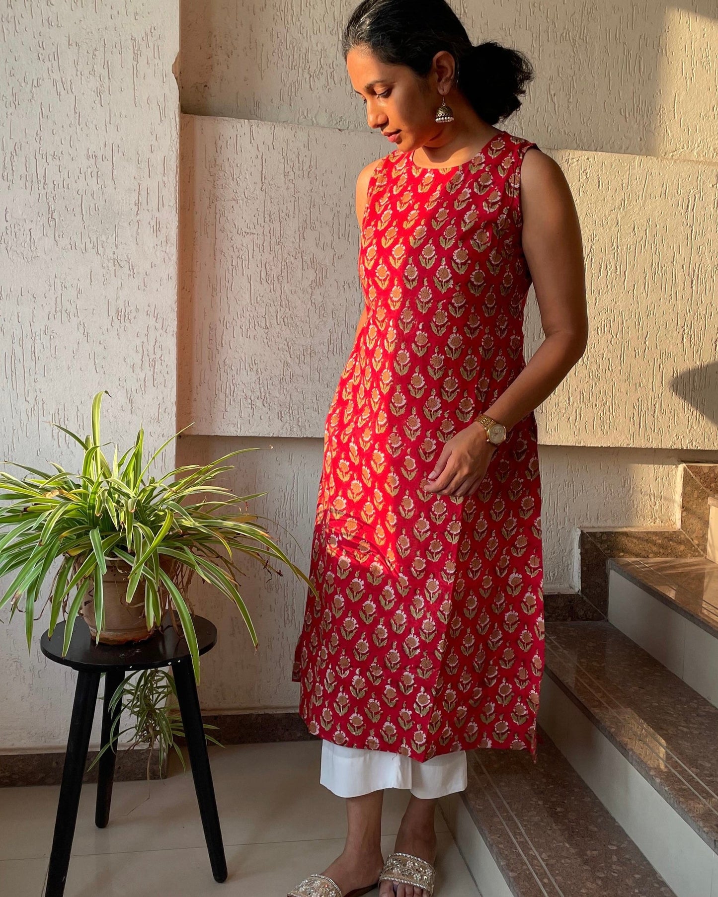 simple red sleeveless block printed kurta for summer. This kurta has pockets on both sides and round neck closure.