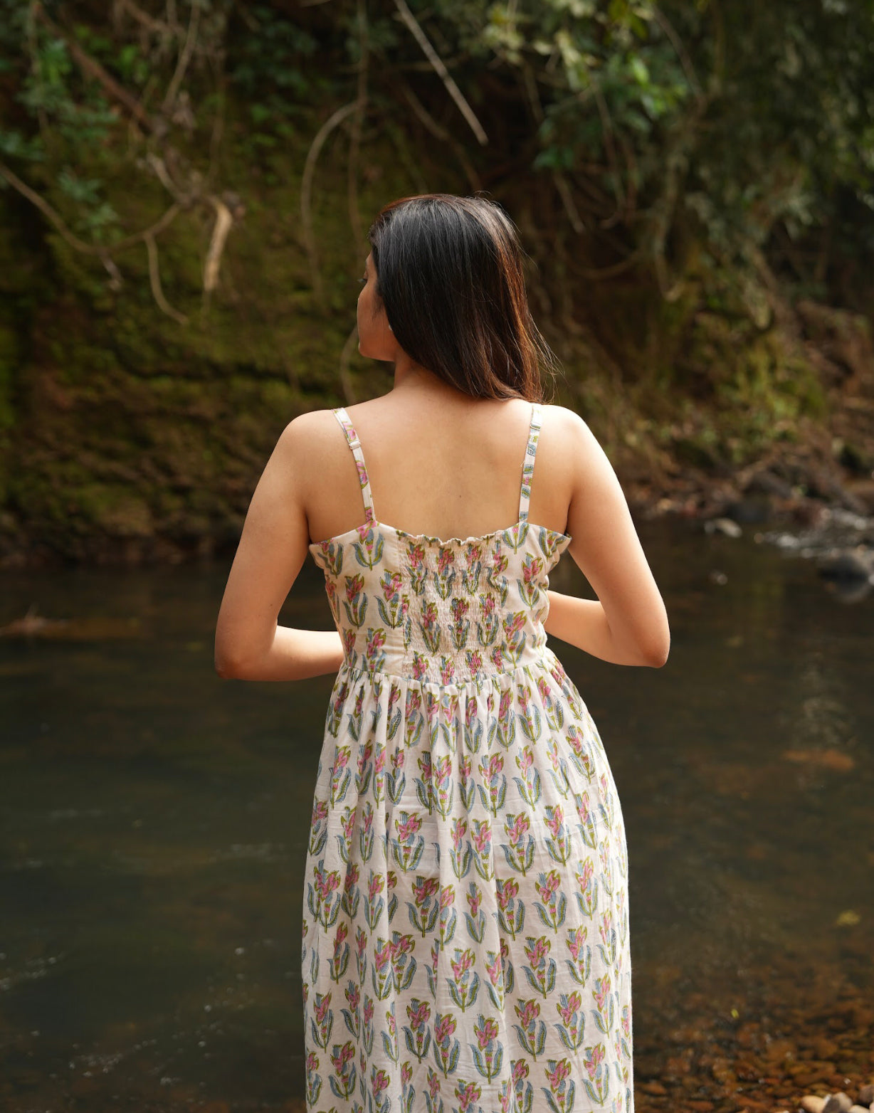 Here is the perfect long cotton dress! Handcrafted with adjustable straps, a comfortable smocked back, and a side slit for easy movement. Shop Now!
