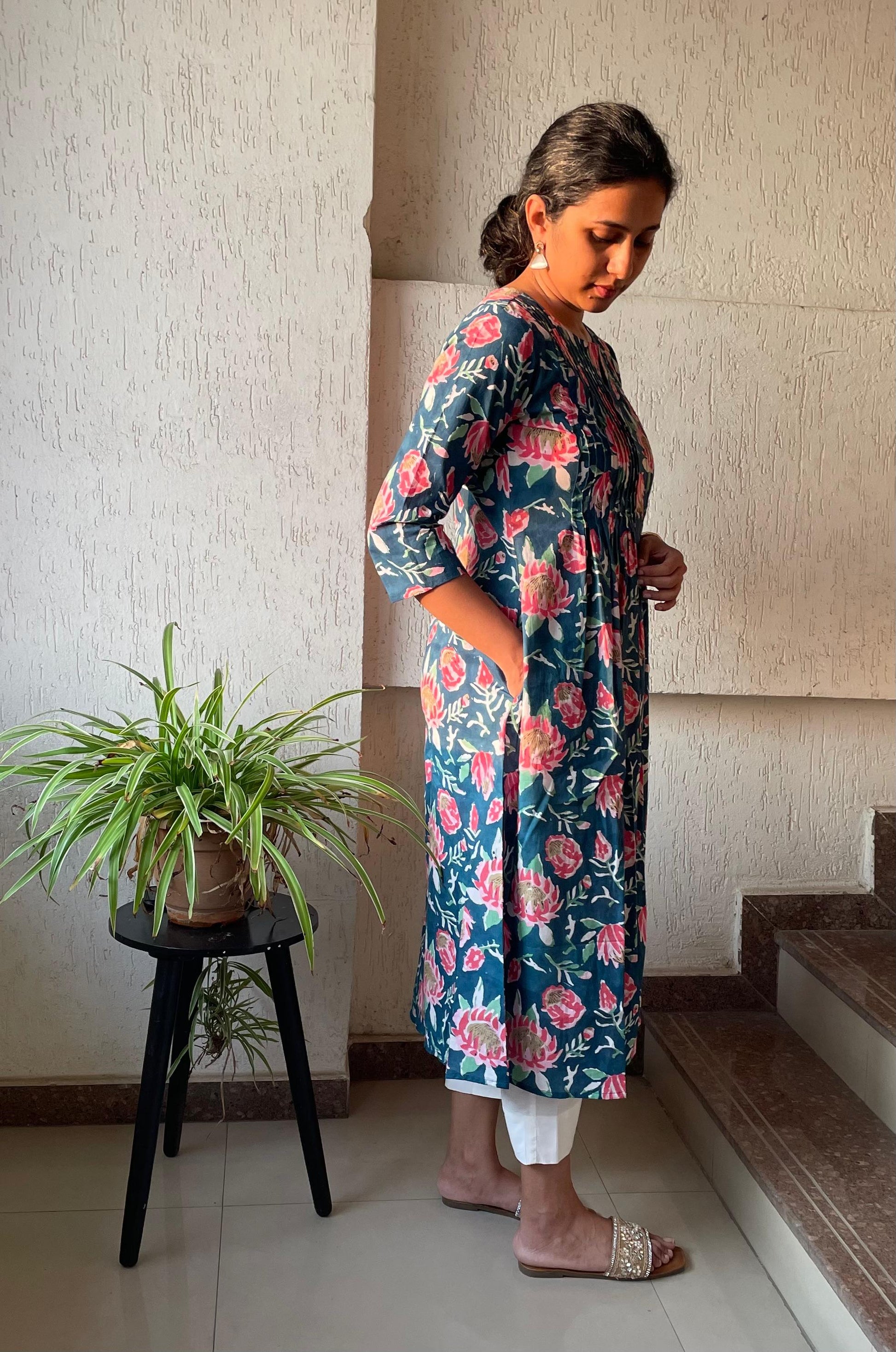 Buy pure cotton kurtas online. This floral kurta with pintuck detailing and sleeves are perfect for summer.