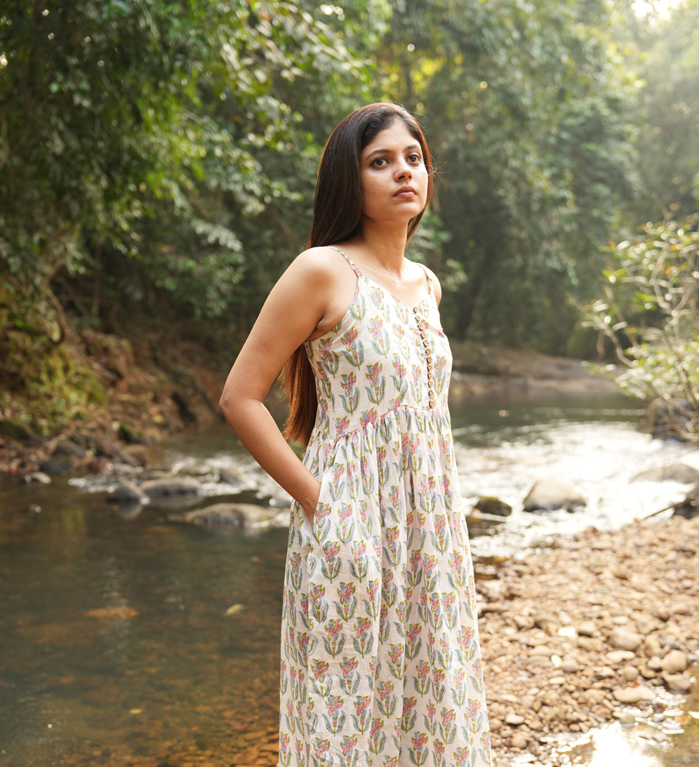 Here is the perfect long cotton dress! Handcrafted with adjustable straps, a comfortable smocked back, and a side slit for easy movement. Shop Now!