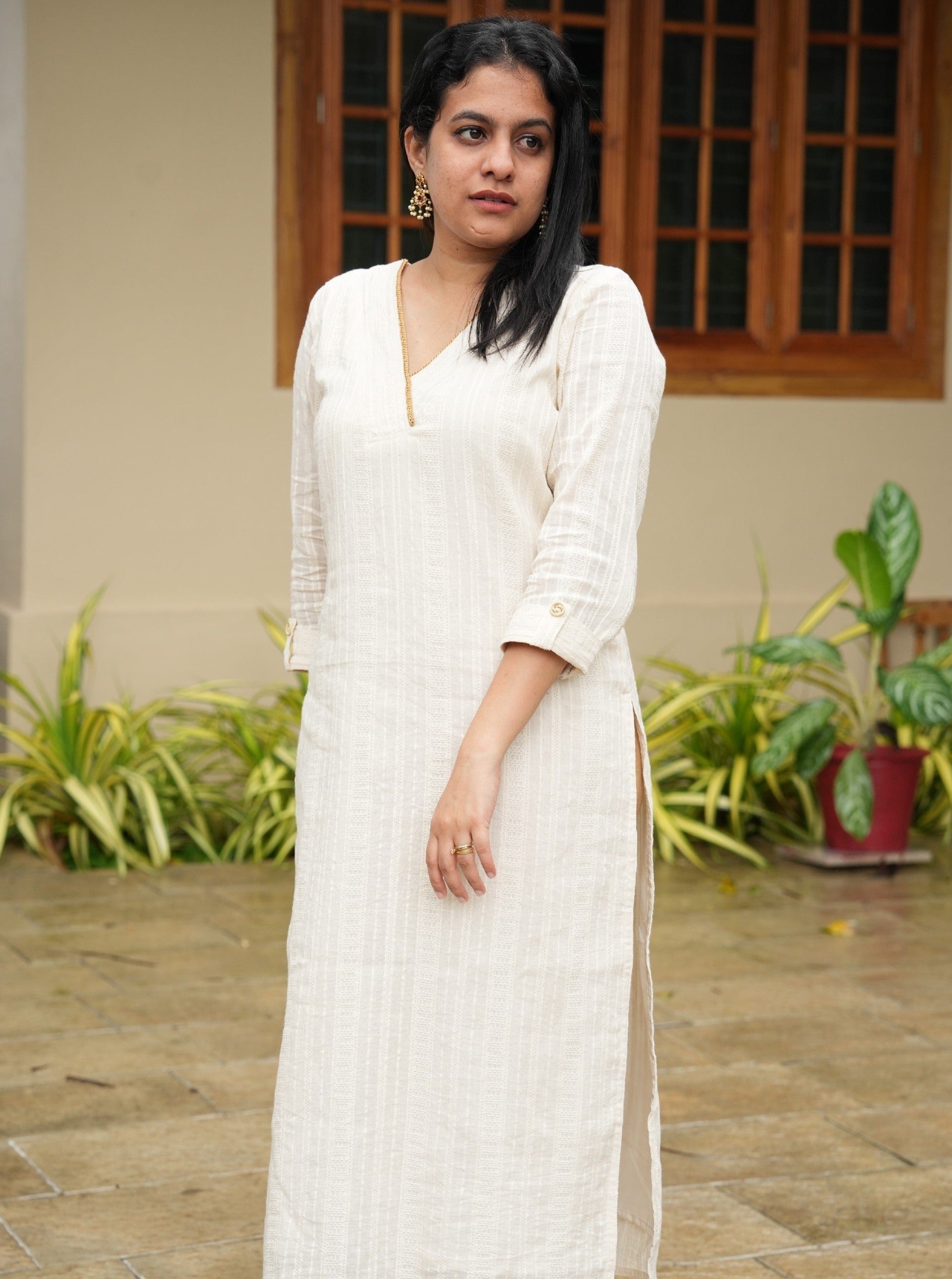off-white cotton kurti with golden lace detailing on the neck. Onam kurta for women.