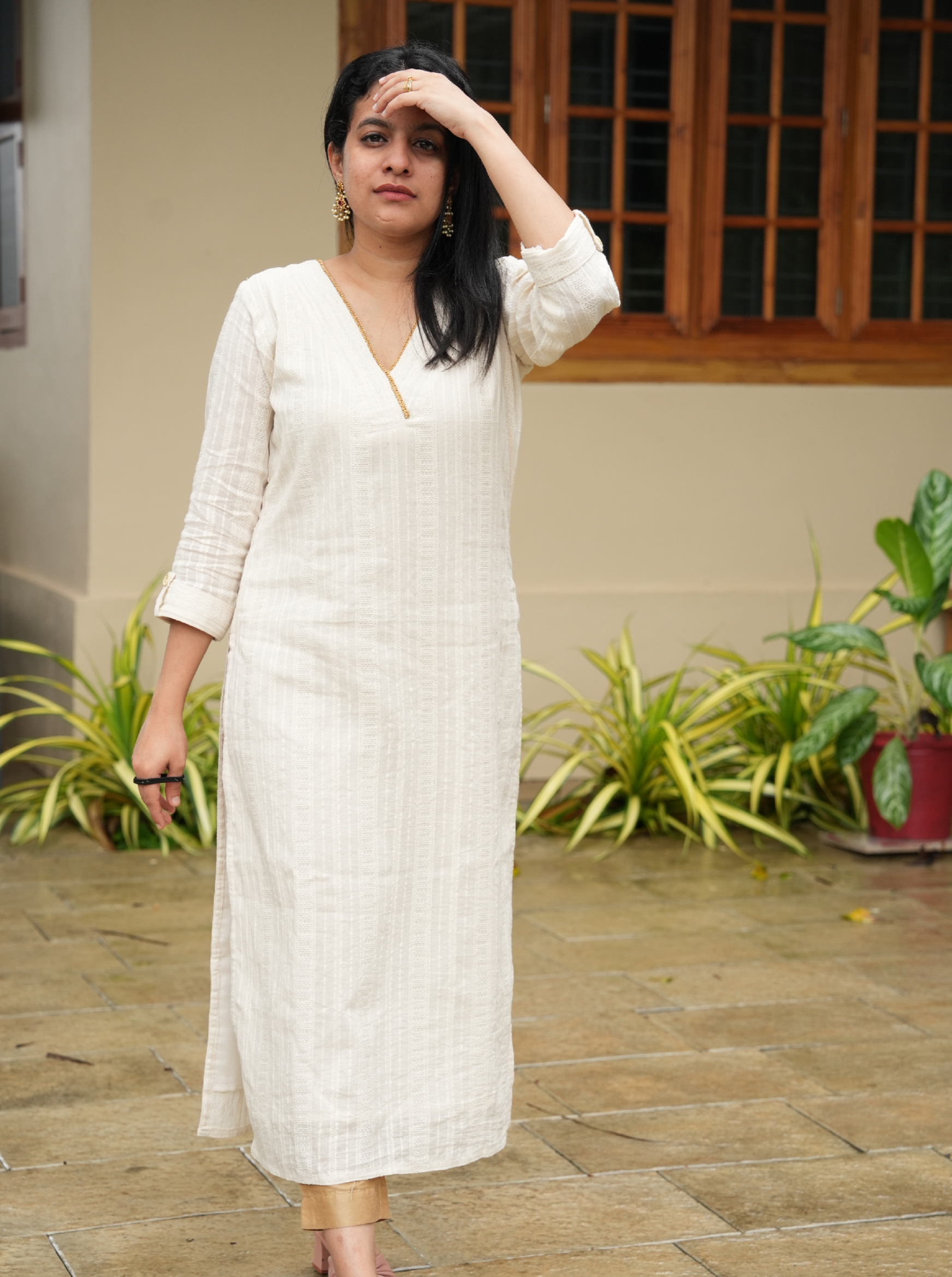 off-white cotton kurti with golden lace detailing on the neck. Perfect for Onam.
