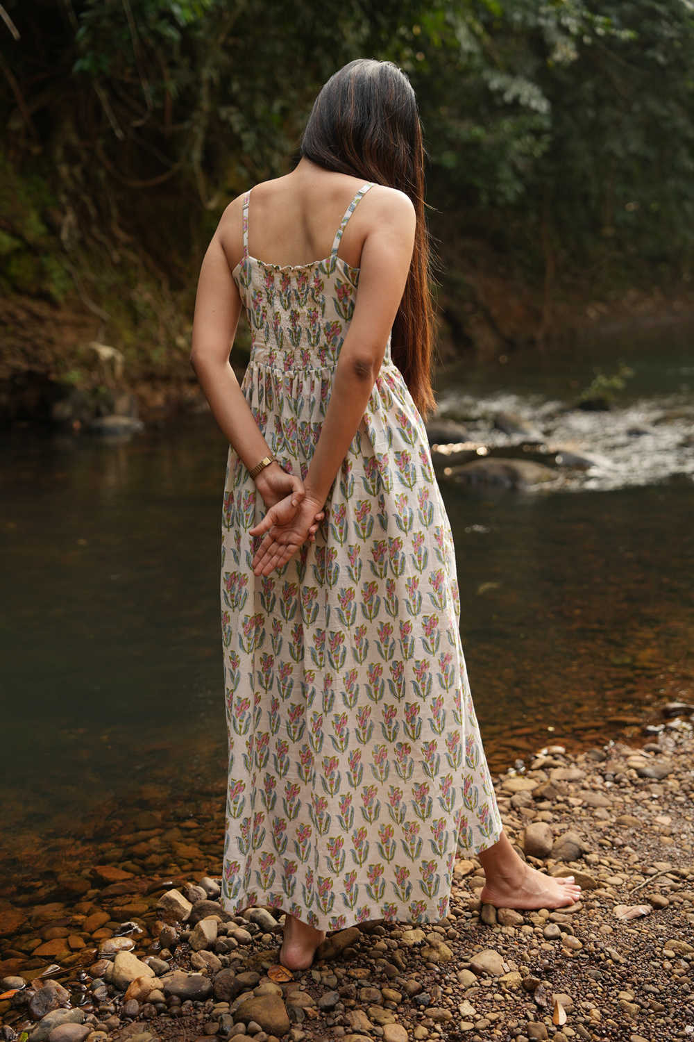 Here is the perfect long cotton dress! Handcrafted with adjustable straps, a comfortable smocked back, and a side slit for easy movement. Shop Now!
