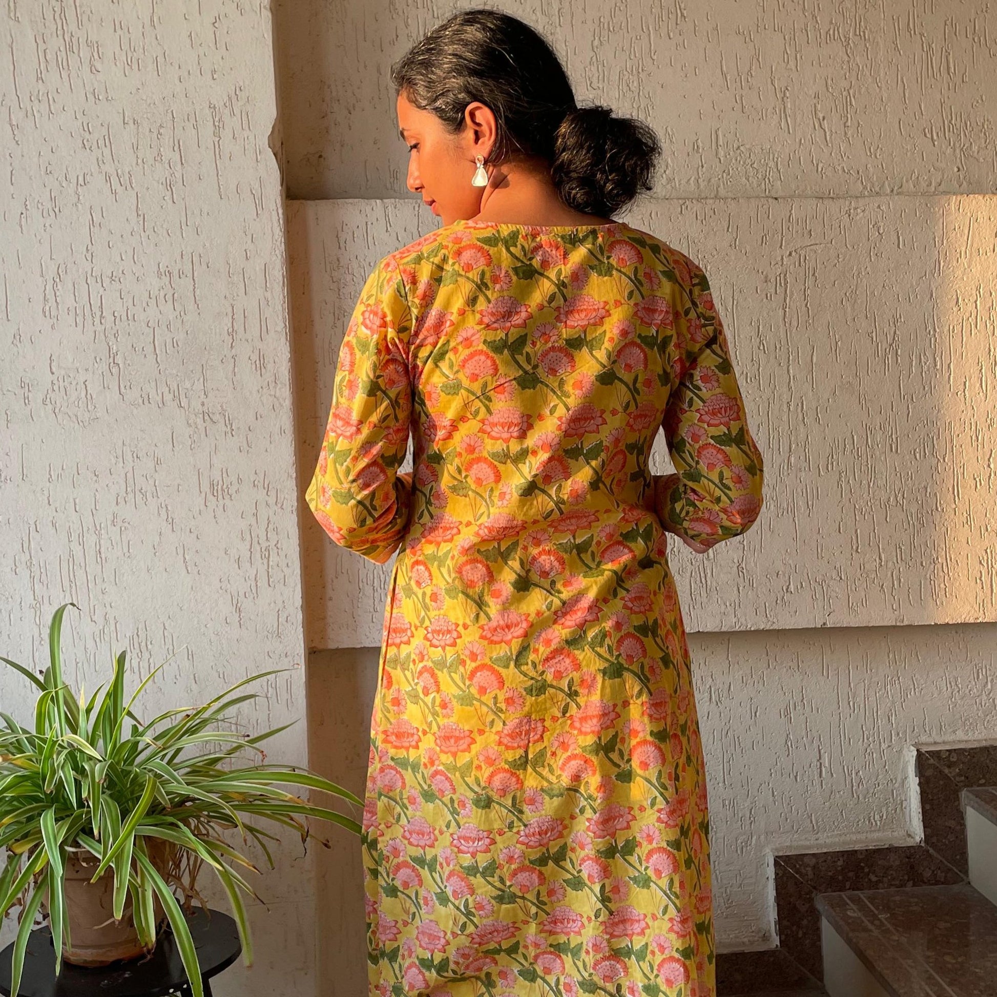Shop yellow hand block printed cotton kurta for women. Long kurta with sleeves, and pintuck detailing on the york, pockets on both sides.